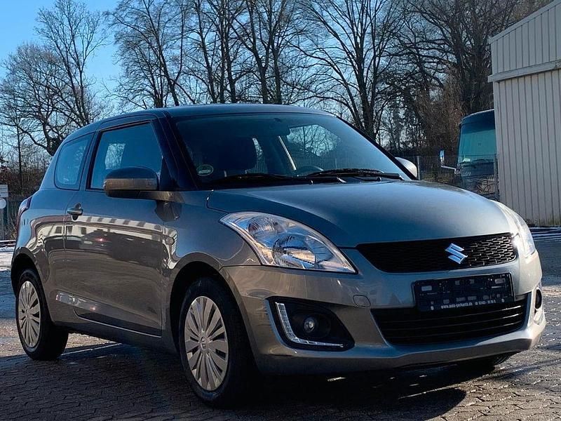 Grau Gebraucht 2015 Suzuki Swift Club Limousine | 6.590 € (Guter Preis) - Bild 1/4