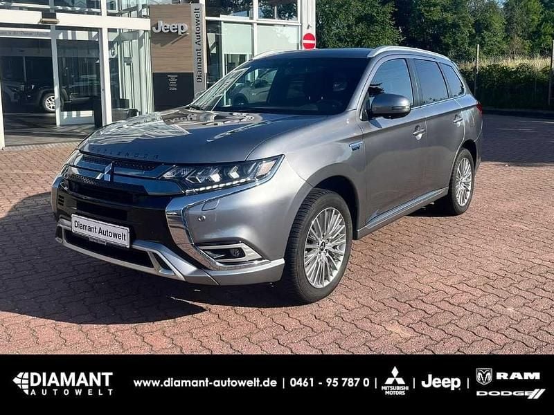 Platinumgrau Gebraucht 2021 Mitsubishi Outlander P-HEV Plus SUV | 22.400 € (Fairer Preis) - Bild 1/4