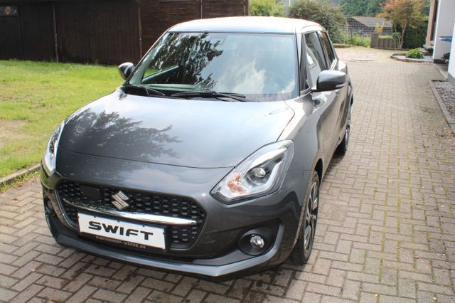 Mineral gray Gebraucht 2023 Suzuki Swift Comfort+ Kleinwagen | 19.450 € (Fairer Preis) - Bild 1/4