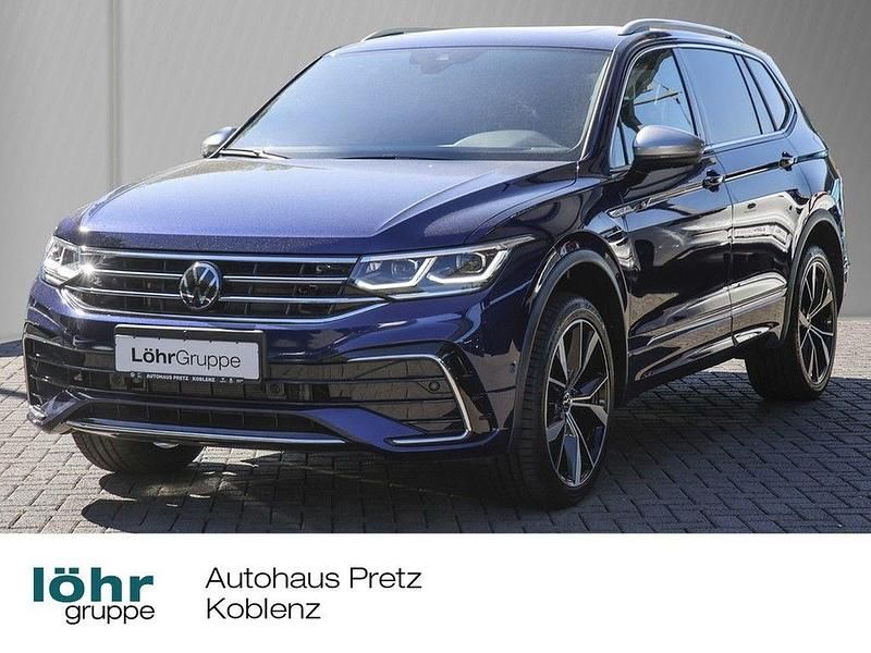 Atlantic blue metallic Gebraucht 2024 VW Tiguan Allspace R-line SUV | 46.980 € (Teuer) - Bild 1/4