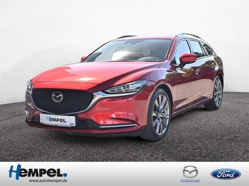 Grau / machine gray (metallic) Gebraucht 2019 Mazda 6 Sports-Line Kombi | 23.990 € (Fairer Preis) - Bild 1/4