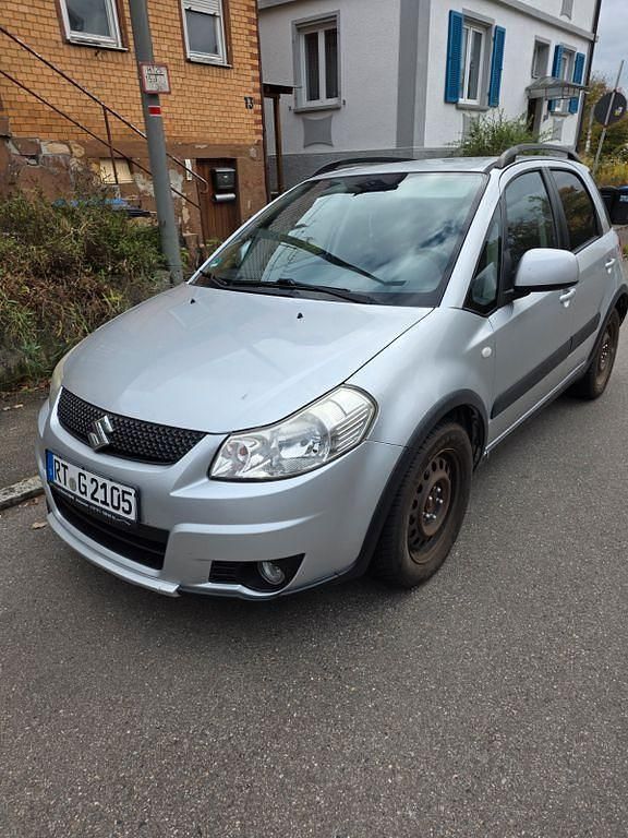 Silber Gebraucht 2009 Suzuki SX4 Comfort Limousine | 4.999 € (Fairer Preis) - Bild 1/4