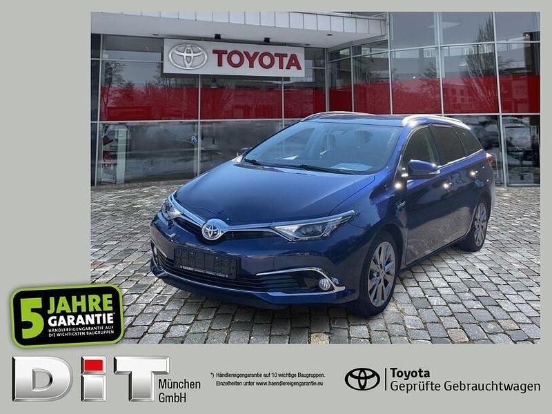 Dark blue mica (metallic) Gebraucht 2016 Toyota Auris Hybrid Executive Kombi | 18.990 € (Teuer) - Bild 1/4
