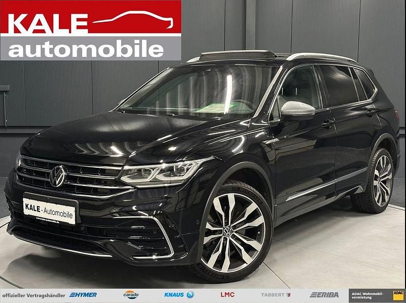 Schwarz metallic (deep black perleffekt) Gebraucht 2022 VW Tiguan Allspace R-line SUV | 35.890 € (Fairer Preis) - Bild 1/4