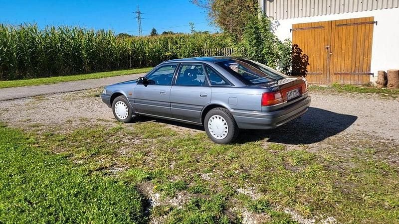 Grau Gebraucht 1991 Mazda 626 Limousine | 3.900 € - Bild 1/4