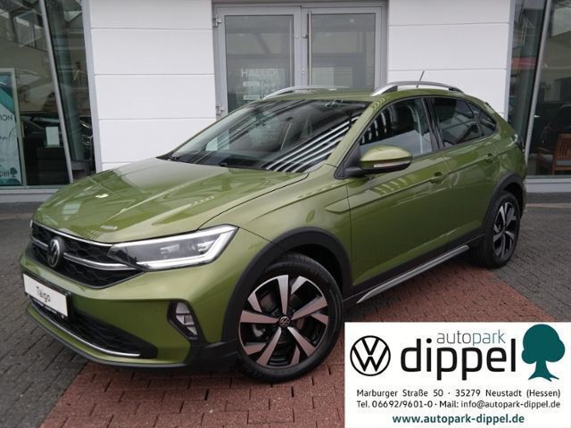 Visual green metallic (metallic) Gebraucht 2022 VW Taigo Style SUV | 21.550 € (Fairer Preis) - Bild 1/4