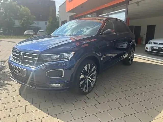 Petroleum blue metallic Gebraucht 2020 VW T-Roc R-line SUV | 20.490 € (Fairer Preis) - Bild 1/4