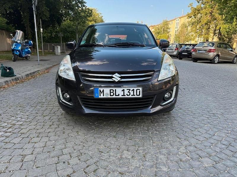 Grau Gebraucht 2015 Suzuki Swift X-TRA Limousine | 4.999 € (Superpreis) - Bild 1/4