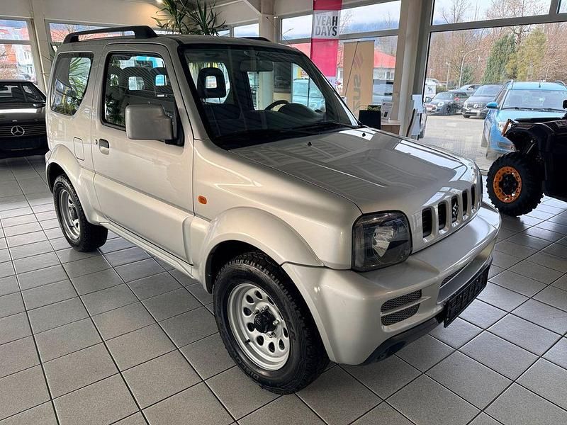 Silber Gebraucht 2012 Suzuki Jimny Comfort SUV | 18.450 € - Bild 1/4