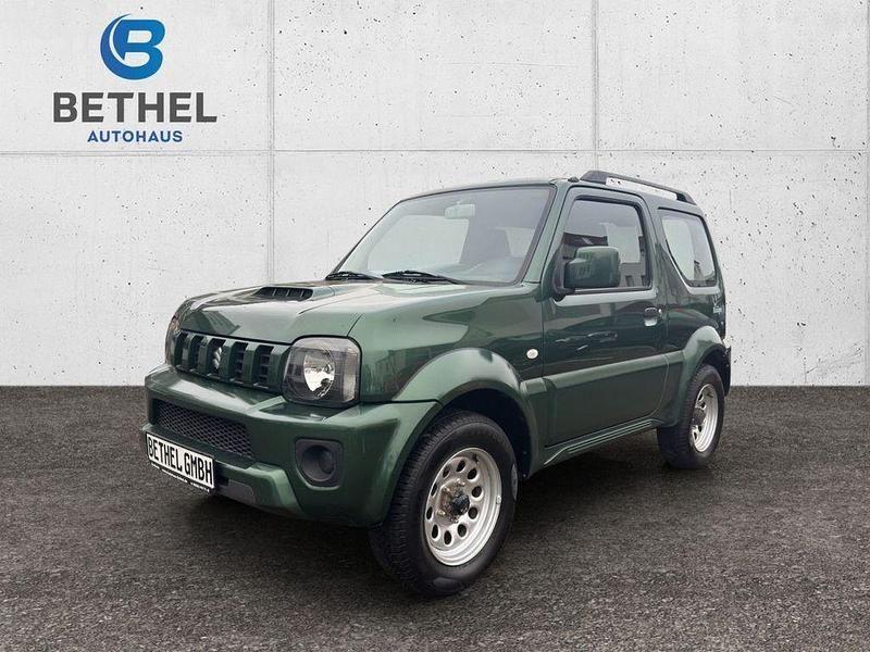 Grün Gebraucht 2013 Suzuki Jimny Club SUV | 10.990 € (Fairer Preis) - Bild 1/4
