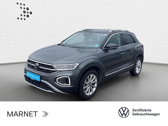Indiumgrau metallic/schwarz Gebraucht 2024 VW T-Roc Style SUV | 28.290 € (Fairer Preis) - Bild 1/3