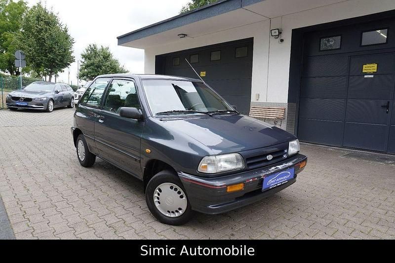 Grau Gebraucht 1996 Kia Pride 4 Limousine | 1.999 € - Bild 1/4