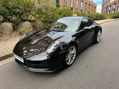 Gebraucht Porsche 911 Carrera 394 PS (289 kW) 2025 Tiefschwarz metallic Coupé