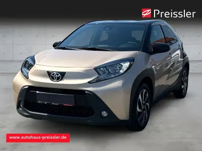 Gebraucht Toyota Aygo X Pulse 72 PS (52 kW) 2023 Ginger beige (4u9)/ black mica SUV