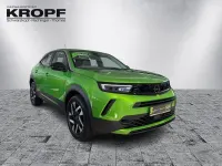 Gebraucht Opel Mokka Elegance 101 PS (74 kW) 2024 Lackierung matcha green/typ au SUV