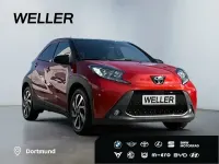 Gebraucht Toyota Aygo 72 PS (52 kW) 2023 Chili red / night sky black (rot) Kleinwagen