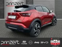 Gebraucht Nissan Juke 143 PS (105 kW) 2023 Fuji sunset red/black SUV