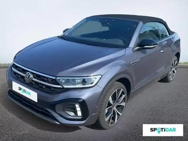 Gris cendré métallisée, capote noire Utilisé 2024 VW T-Roc Cabriolet R-line Cabriolet | 35 590 € (Prix juste) - Image 1/4