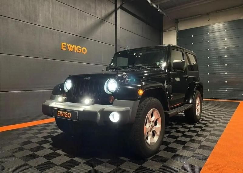 Noir Occasion 2013 Jeep Wrangler Sahara SUV | 37 490 € (Prix assez cher) - Image 1/4