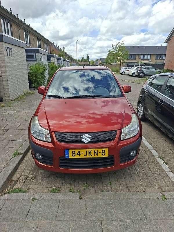 Oranje Gebruikt 2009 Suzuki SX4 Exclusive Hatchback | € 4.000 (Eerlijke prijs) - Afbeelding 1/4