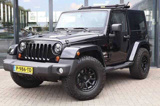 Zwart Gebruikt 2011 Jeep Wrangler Sahara SUV | € 37.950 - Afbeelding 1/4