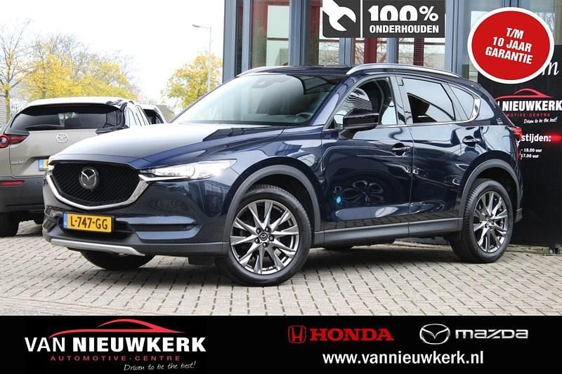 Deep chrysthal blue (blauw mica) Gebruikt 2021 Mazda CX-5 Signature SUV | € 33.900 (Eerlijke prijs) - Afbeelding 1/4