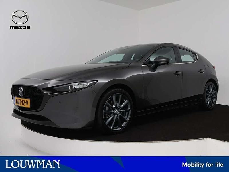 Machine grey (grijs metallic) Occasion 2024 Mazda 3 Exclusive-Line Hatchback | € 34.895 (Duur) - Afbeelding 1/3