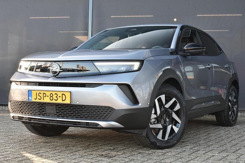 Grijs Gebruikt 2025 Opel Mokka-e Business Edition SUV | € 33.895 - Afbeelding 1/4