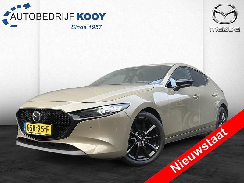 Zircon sand (bruin metallic) Gebruikt 2024 Mazda 3 Nagisa Hatchback | € 31.495 (Eerlijke prijs) - Afbeelding 1/4