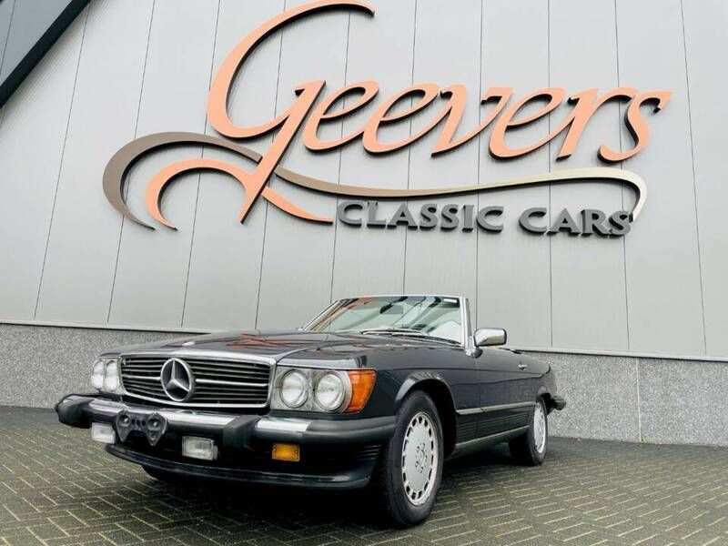 Blauwblueblack metallic 199h Gebruikt 1988 Mercedes 560 Cabriolet | € 23.950 - Afbeelding 1/4