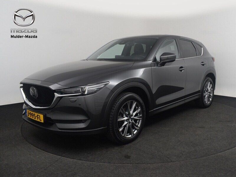 Machine gray (grijs metallic) Gebruikt 2020 Mazda CX-5 Signature SUV | € 30.950 (Eerlijke prijs) - Afbeelding 1/4