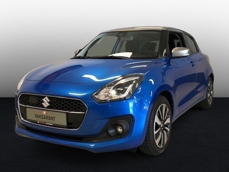 Blauw, metallic lak Gebruikt 2018 Suzuki Swift Style Hatchback | € 14.950 (Eerlijke prijs) - Afbeelding 1/4