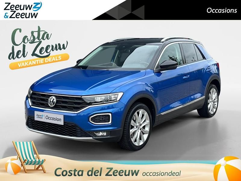 Ravenna blue / zwart dak (donker blauw) Gebruikt 2018 VW T-Roc Style SUV | € 19.935 (Eerlijke prijs) - Afbeelding 1/4