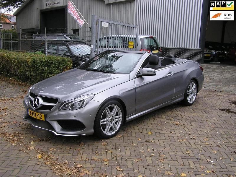 Grijs (metallic) Occasion 2014 Mercedes E200 AMG line Cabriolet | € 22.500 - Afbeelding 1/4