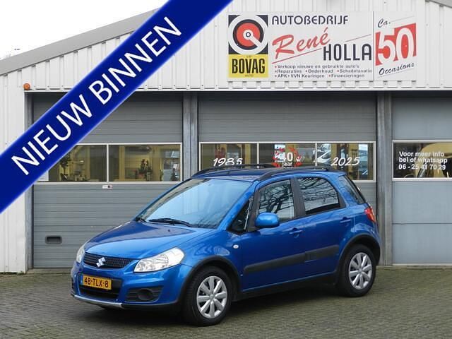 Blauw (metallic) Gebruikt 2012 Suzuki SX4 Comfort MPV | € 6.940 (Eerlijke prijs) - Afbeelding 1/4