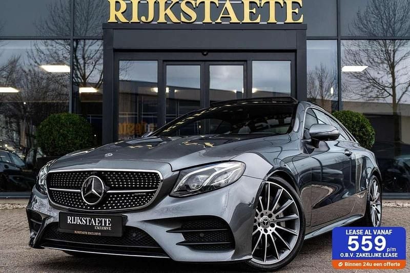 Grijs (metallic) Gebruikt 2018 Mercedes E300 AMG line Coupé | € 34.900 (Goede deal) - Afbeelding 1/4
