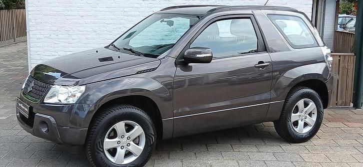 Grijs, metallic lak Occasion 2012 Suzuki Grand Vitara Exclusive SUV | € 15.949 - Afbeelding 1/4