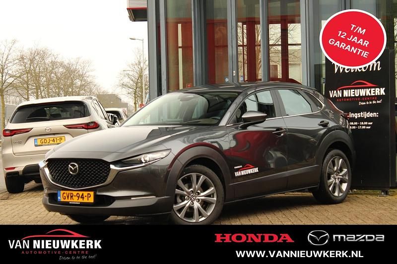 Machine grey (grijs mica) Gebruikt 2024 Mazda CX-30 Exclusive-Line SUV | € 31.400 (Eerlijke prijs) - Afbeelding 1/4