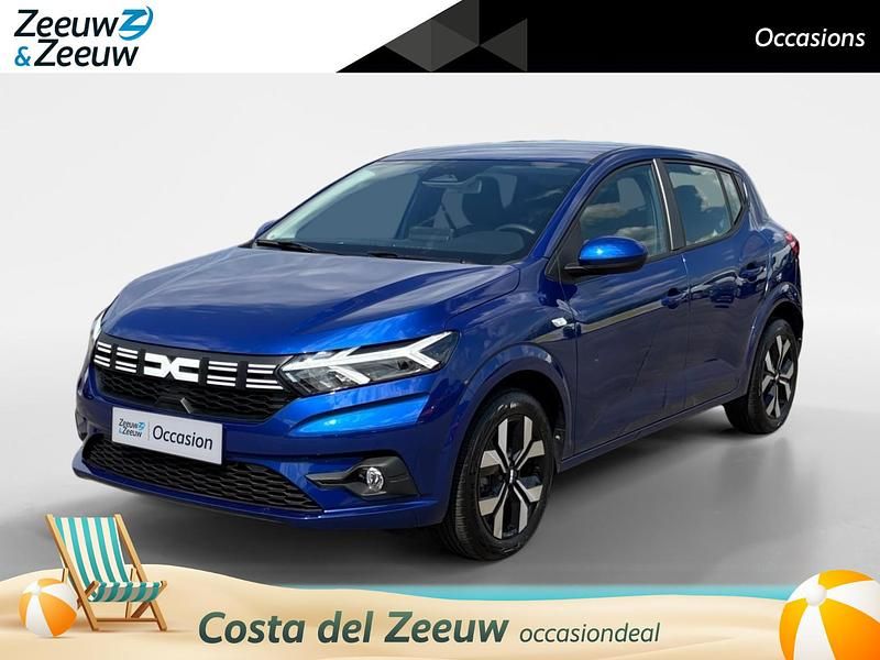Bleu iron (donker blauw) Gebruikt 2024 Dacia Sandero Journey Hatchback | € 20.935 (Eerlijke prijs) - Afbeelding 1/4