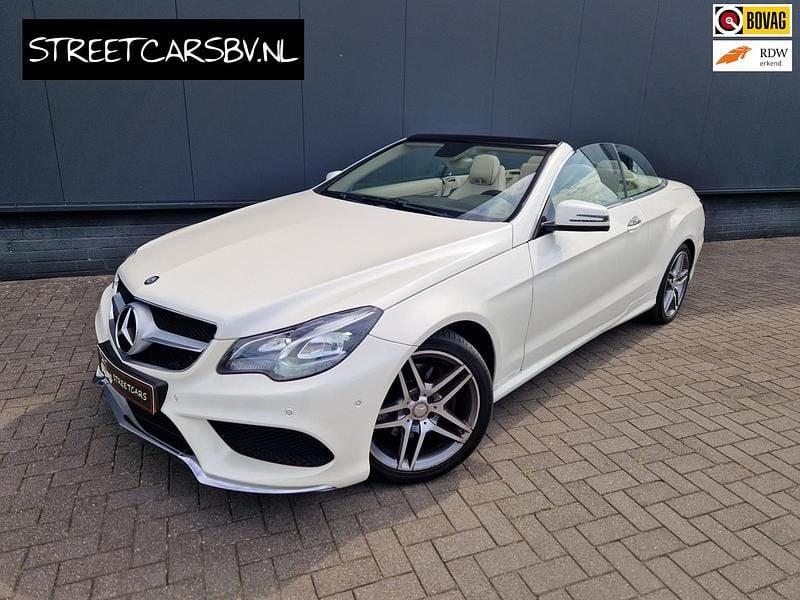 Wit, metallic lak Gebruikt 2015 Mercedes E200 AMG Cabriolet | € 24.950 (Iets duurder) - Afbeelding 1/4
