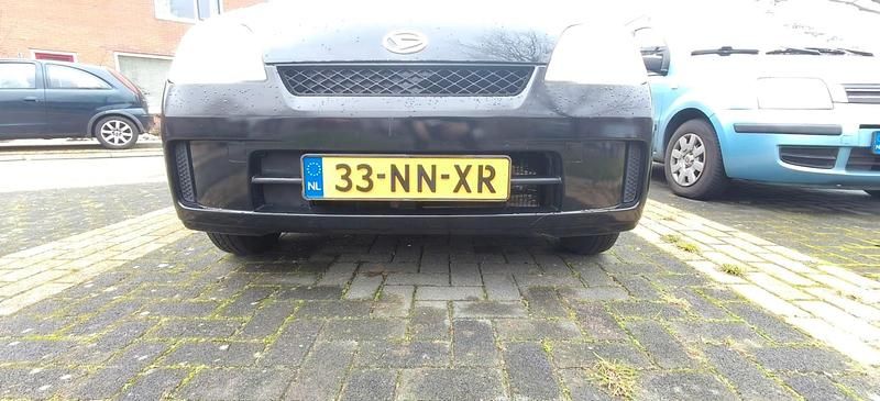 Occasion Daihatsu Cuore 58 PK (42 kW) 2004 Zwart Hatchback