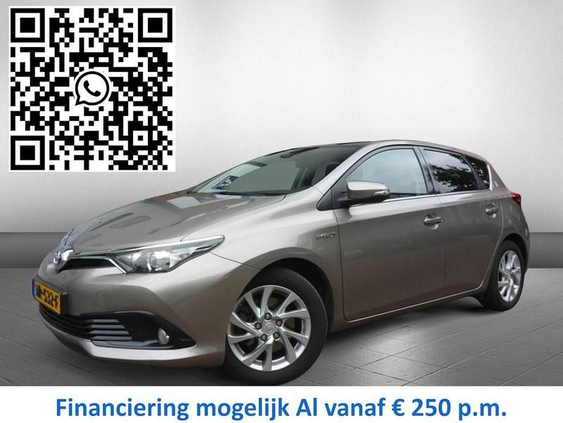 Bruin (metallic) Gebruikt 2016 Toyota Auris Hybrid Hatchback | € 16.445 (Eerlijke prijs) - Afbeelding 1/4