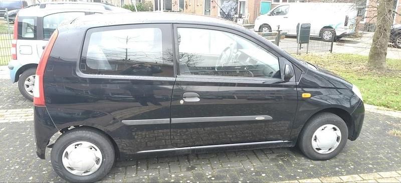 Occasion Daihatsu Cuore 58 PK (42 kW) 2004 Zwart Hatchback