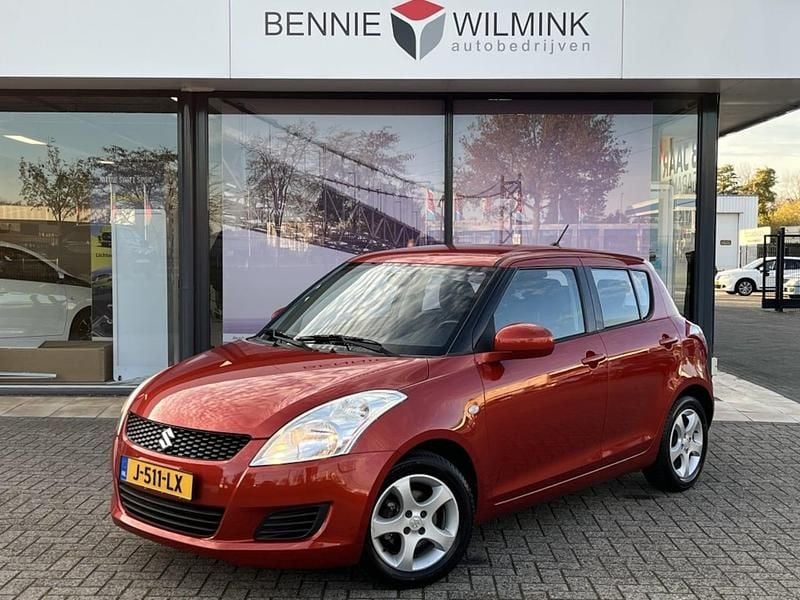 Oranje Gebruikt 2013 Suzuki Swift Comfort Hatchback | € 6.990 (Goede deal) - Afbeelding 1/4