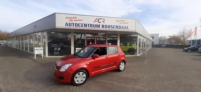 Rood (metallic) Gebruikt 2010 Suzuki Swift Cool Hatchback | € 4.499 (Iets duurder) - Afbeelding 1/4