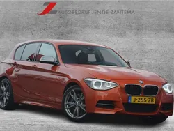 Oranje Gebruikt 2013 BMW M135 Executive Hatchback | € 22.445 (Eerlijke prijs)