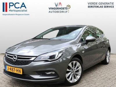 tweedehands Opel Astra Benzine * 105 PK * Super-Zuinig * 5-Deurs * Navigatie * L.M. Velgen * Dode Hoek Detectie * Parkeer Camera * Voor & Achter Sensoren * Climate & Cruise Control *