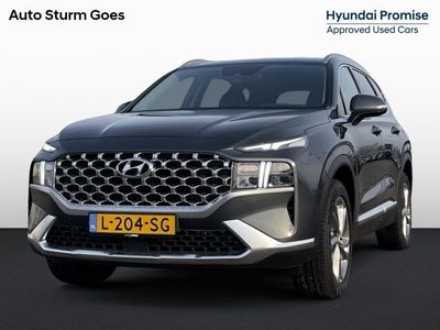 tweedehands Hyundai Santa Fe 1.6 T-GDI HEV Comfort Smart 7p. | Trekhaak | Navigatie | Camera | Stoelvewarming | Apple Carplay/Android Auto | Dodehoek | Adapt. Cruise Control | Premium Audio | Rijklaarprijs!