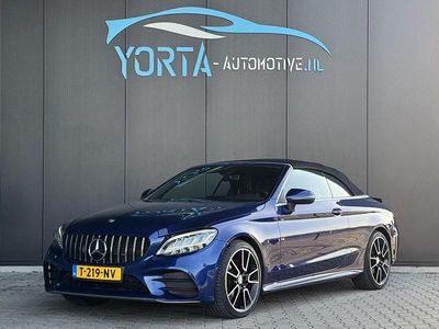 Blauw (metallic) Occasion 2020 Mercedes C200 AMG line Cabriolet | € 39.950