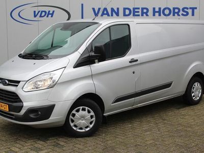 tweedehands Ford Transit Custom 290 2.0-105pk TDCI L2H1 Trend. Nette Custom in de verlengde uitvoering, deze wagen kan u nog jaren tot dienst zijn. Airco, navigatie, telefoonvoorb., voorraamverwarming, lane assist, parkeersensoren v+a, camera, trekhaak, metallic